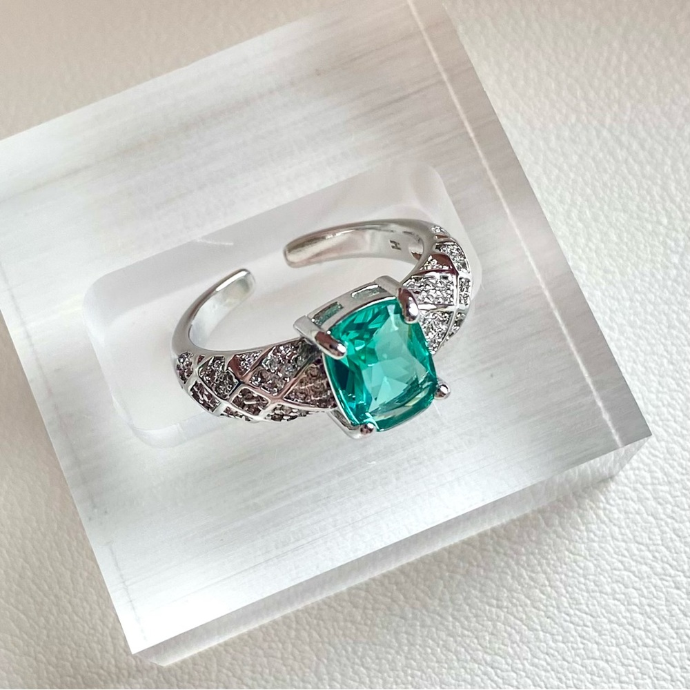 Emerald green ring with pave band